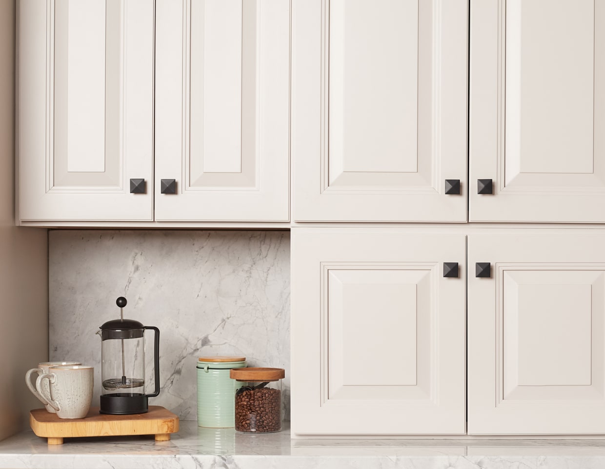 Black handles and knobs on white cabinets